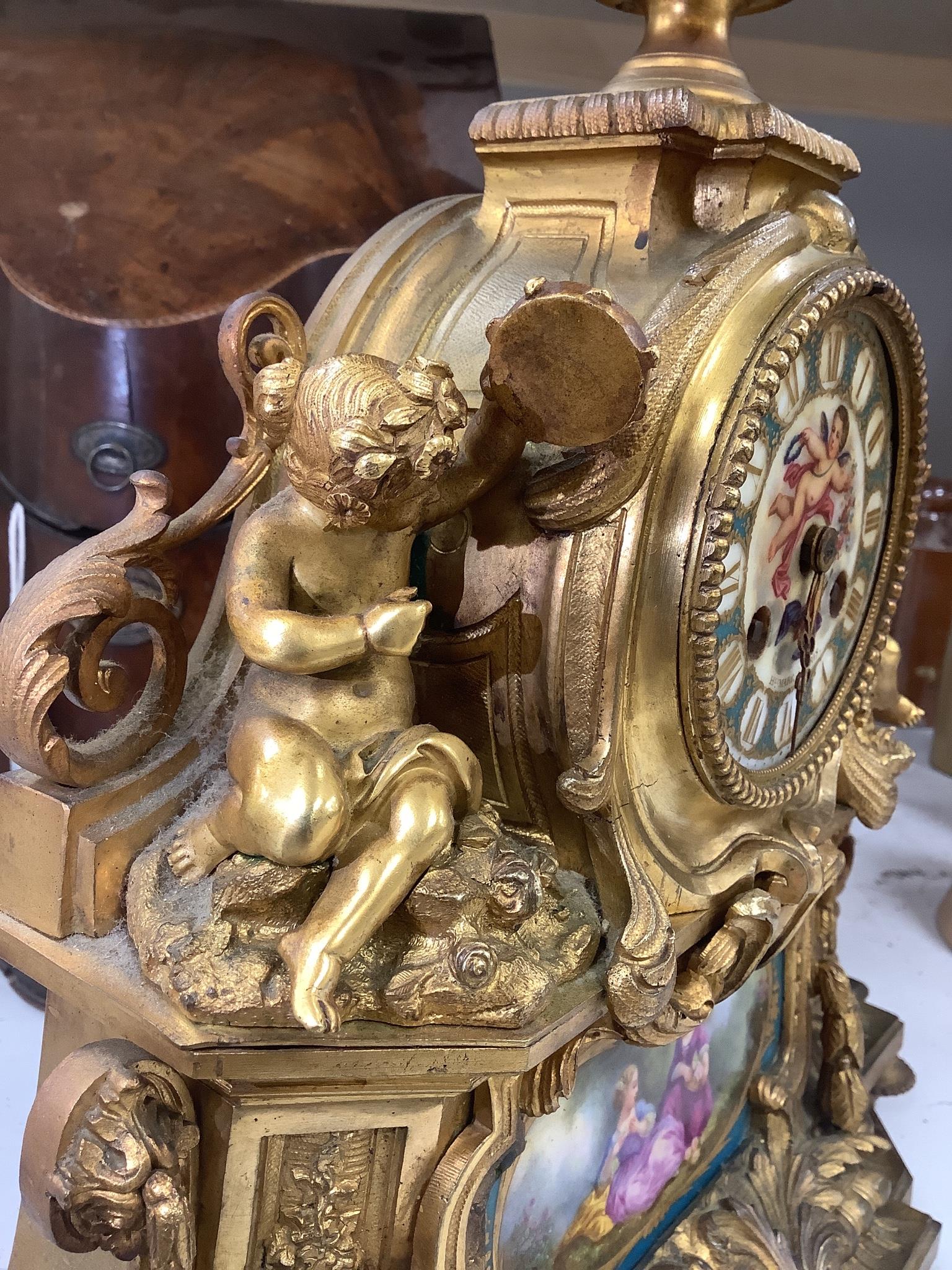 A 19th century French ormolu and Sevres style porcelain mounted mantel clock, with key and pendulum, 35 cm high